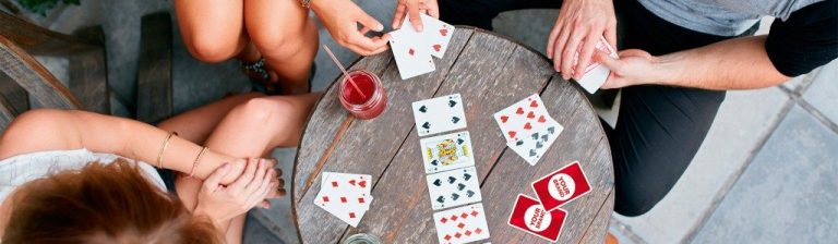 People Playing Together With Playing Cards